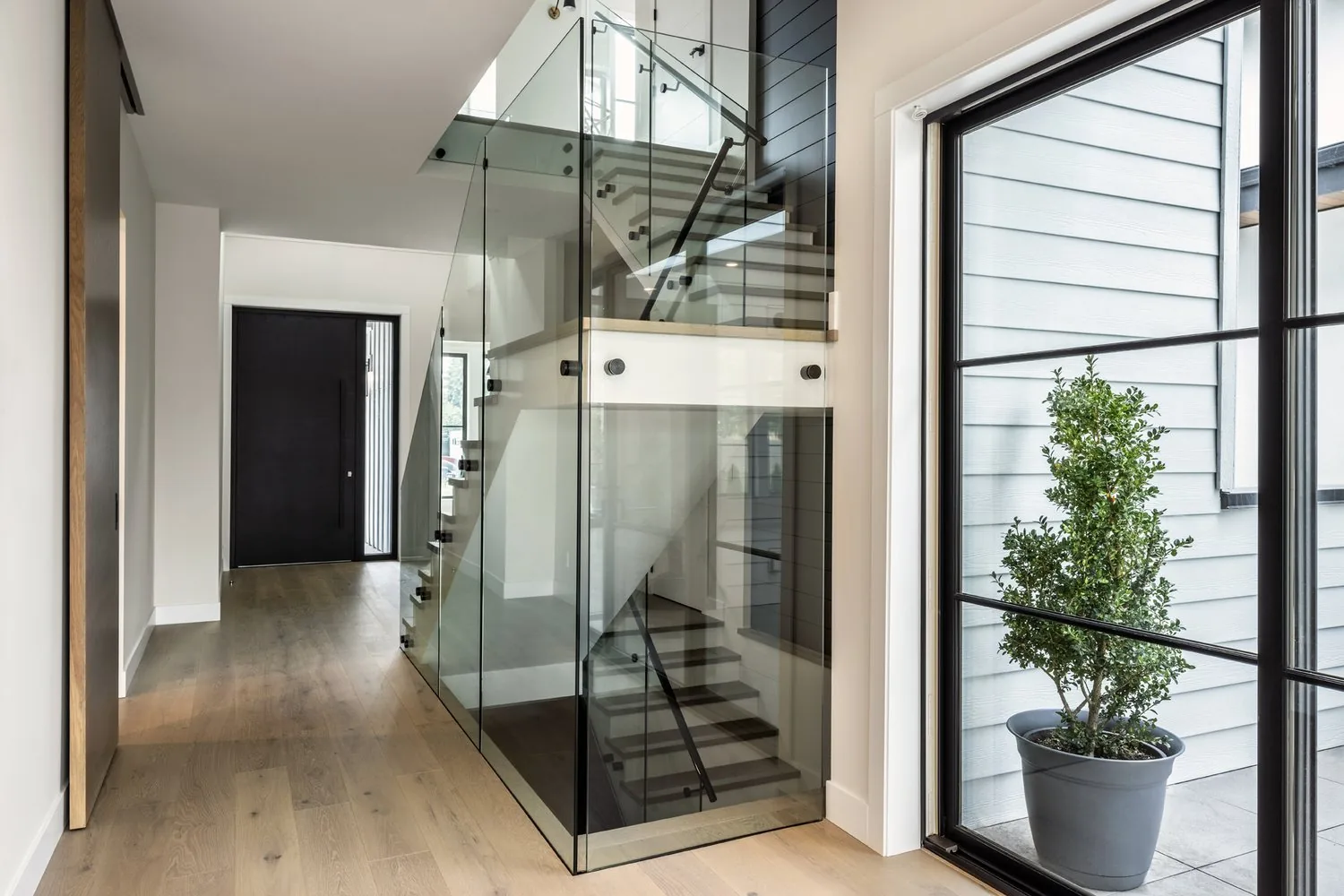 Stair and glass detail in a custom home built by Edward West Luxury Homes